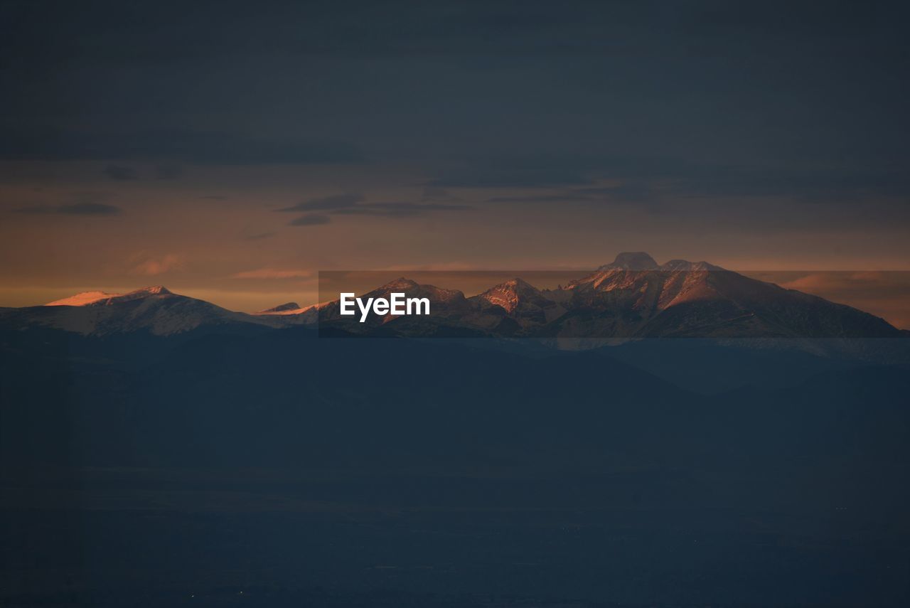 SCENIC VIEW OF SNOWCAPPED MOUNTAINS DURING SUNSET