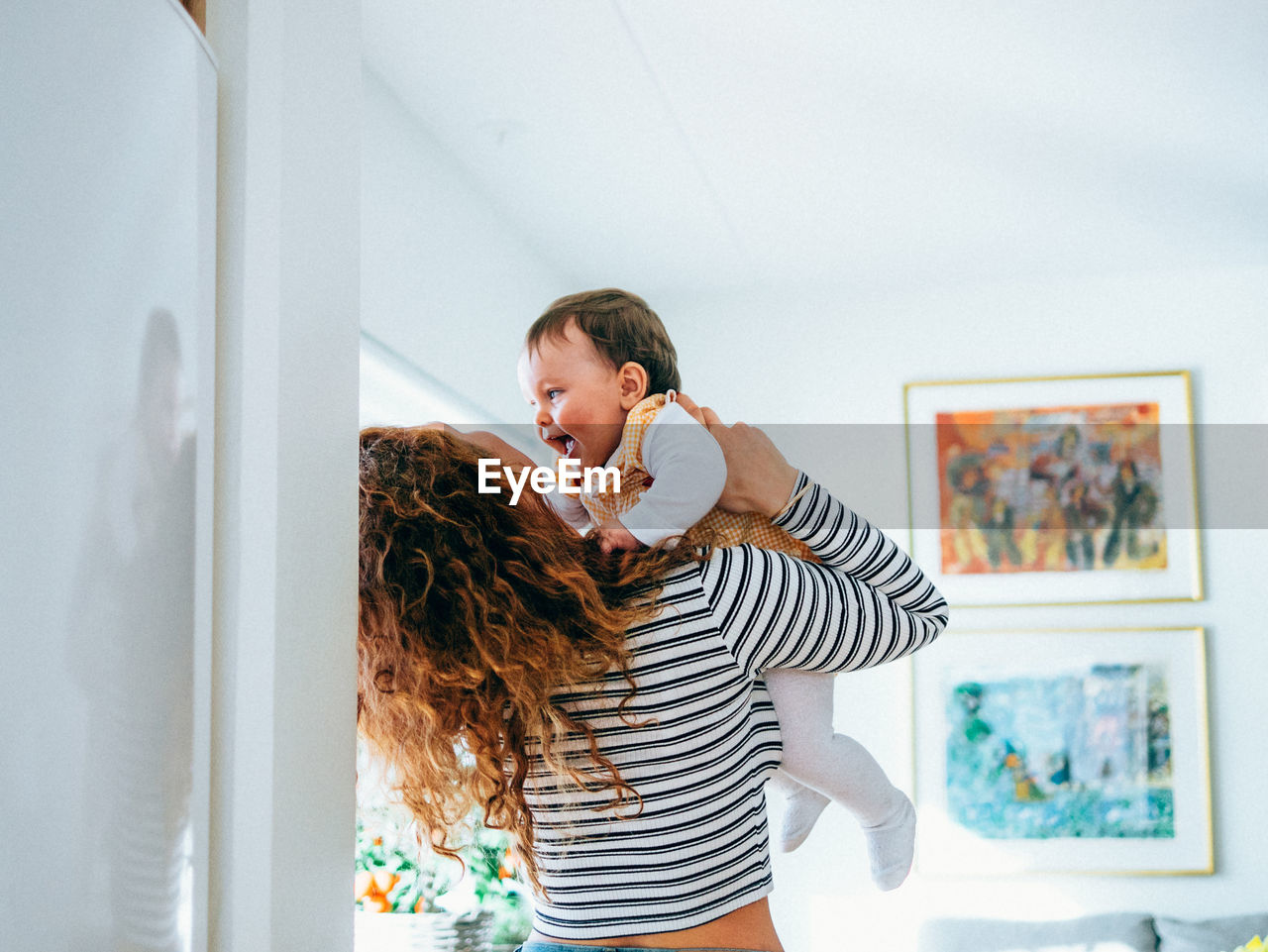 YOUNG WOMAN STANDING AT HOME