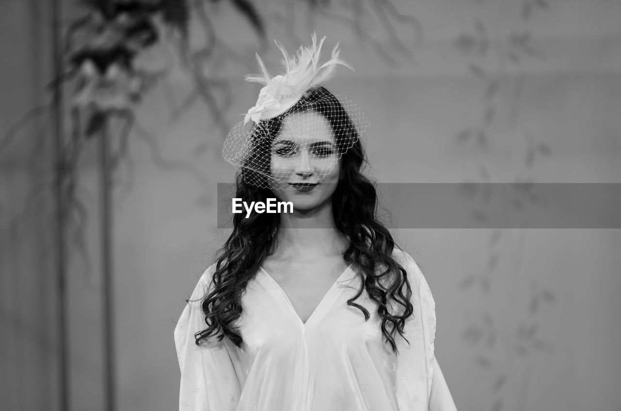 Portrait of a beautiful young woman standing outdoors