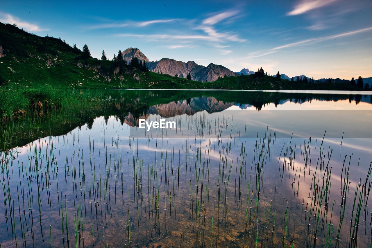 Scenic view of lake against sky during sunset