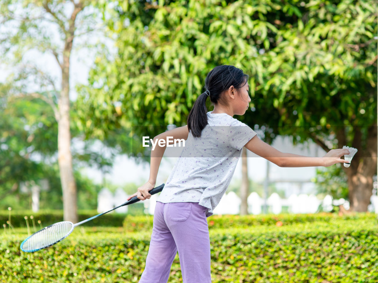 Girl playing badminton at park