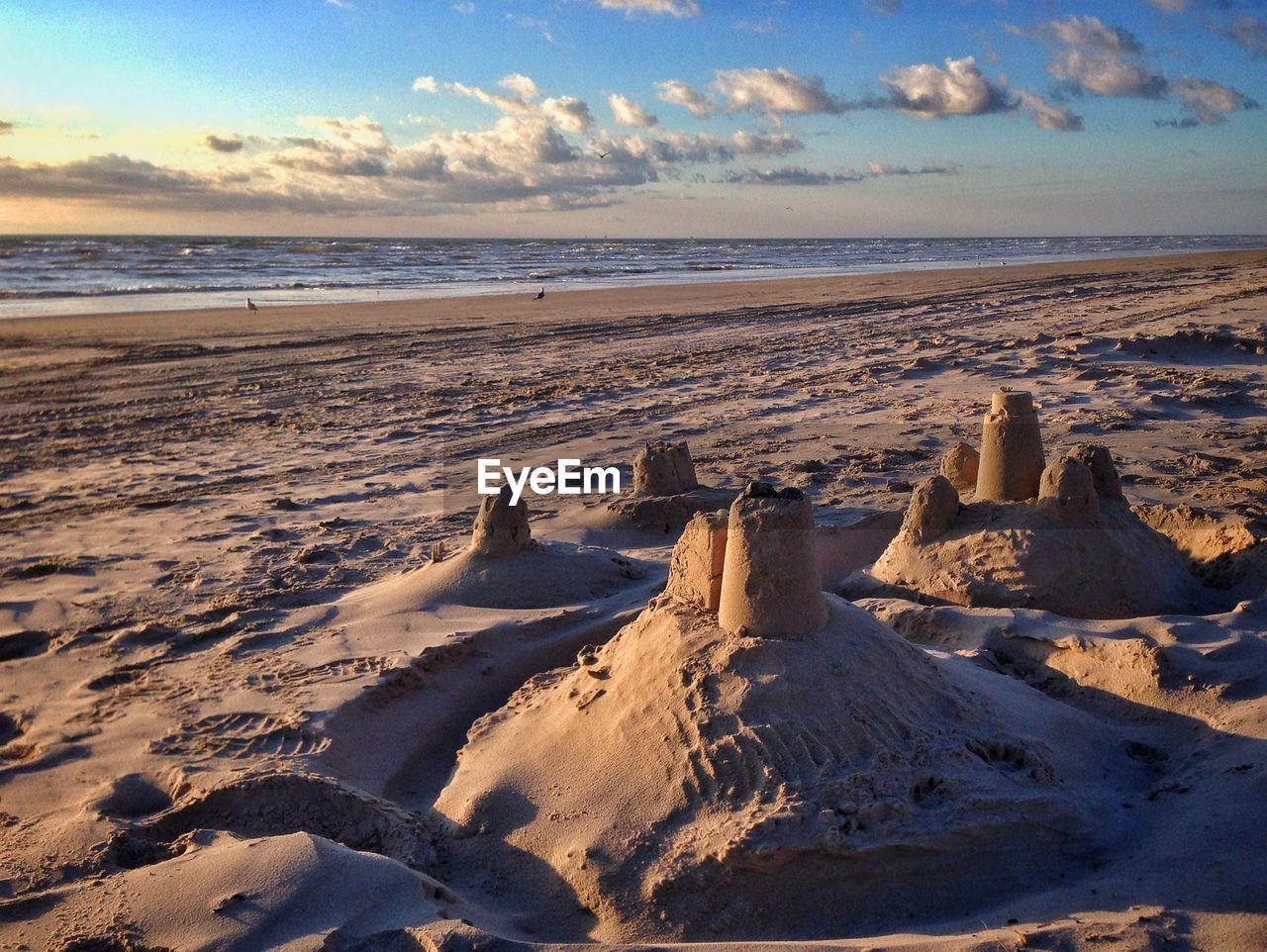 Sand castle on beach against sky