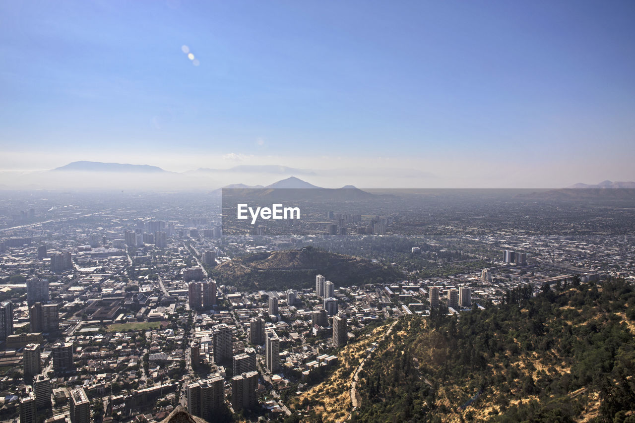 HIGH ANGLE VIEW OF CITYSCAPE AGAINST SKY