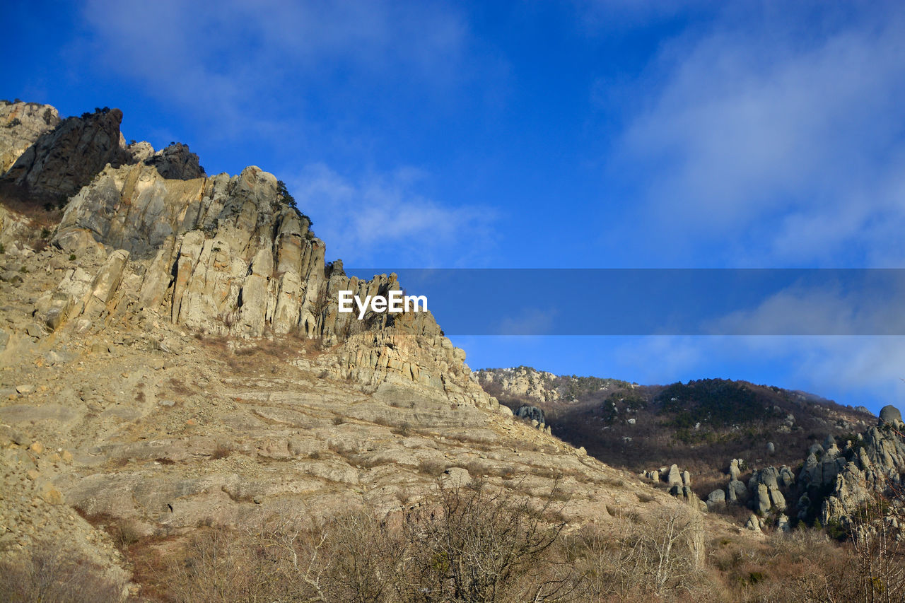 Low angle view of rock formations against sky