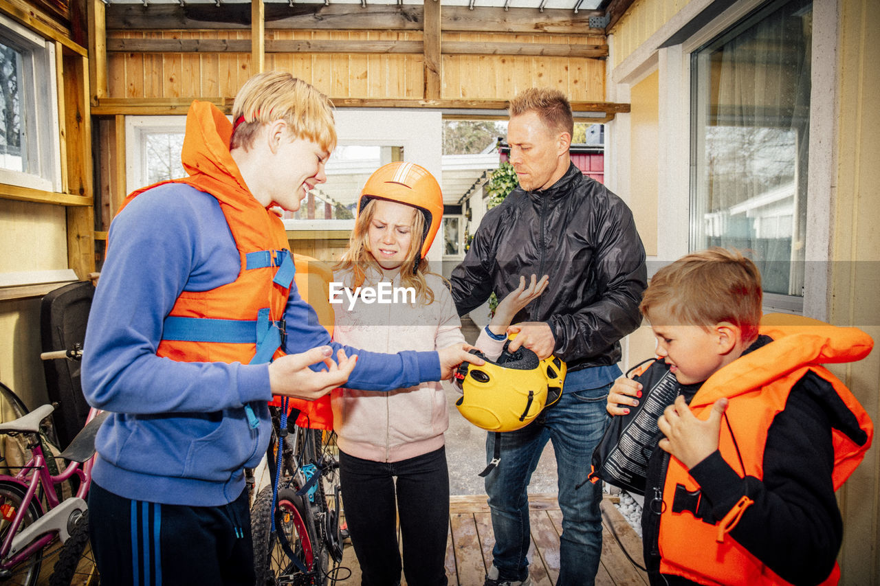 Father with children standing in garage