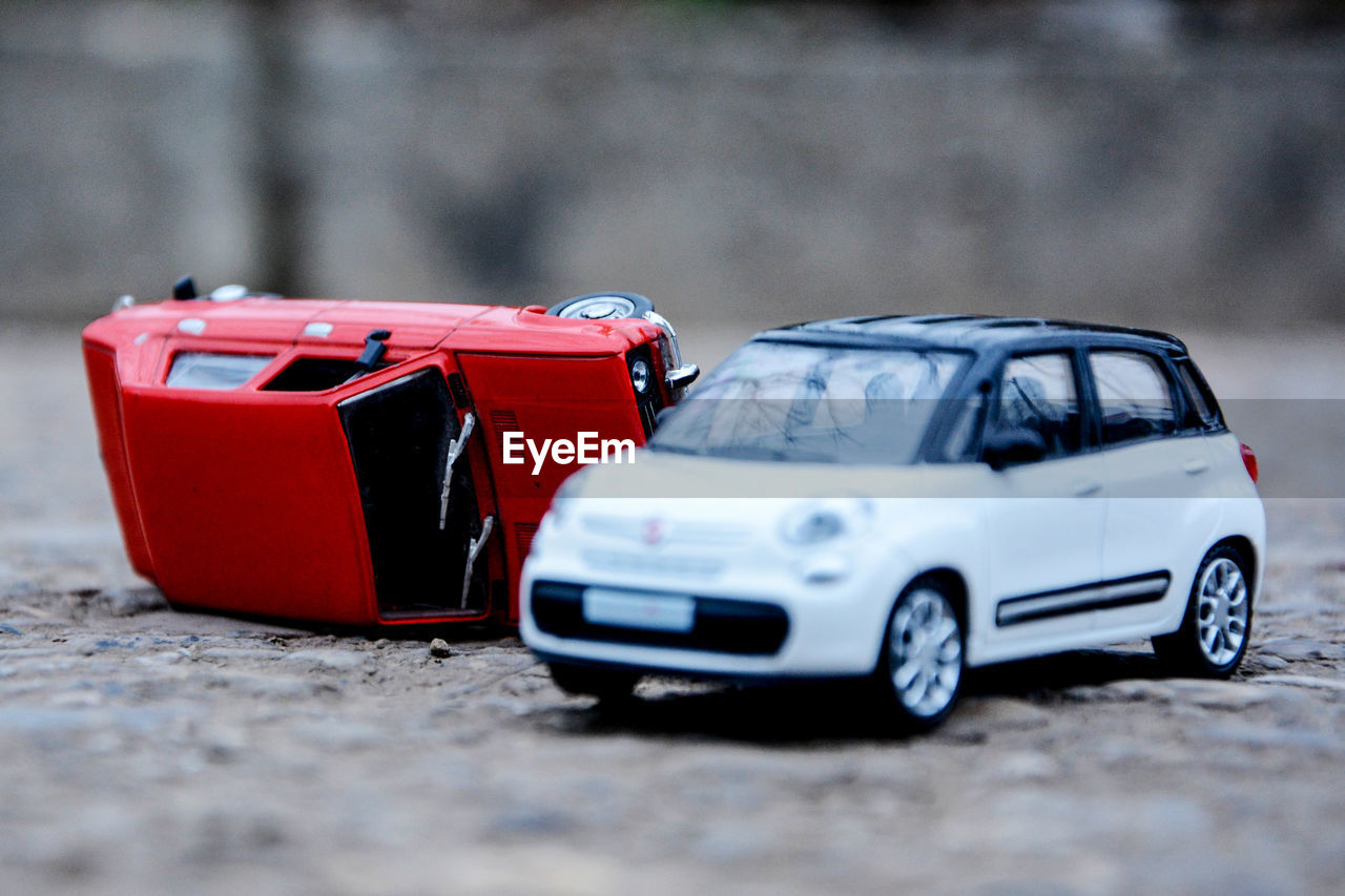 CLOSE-UP OF TOY CAR AGAINST BLURRED MOTION