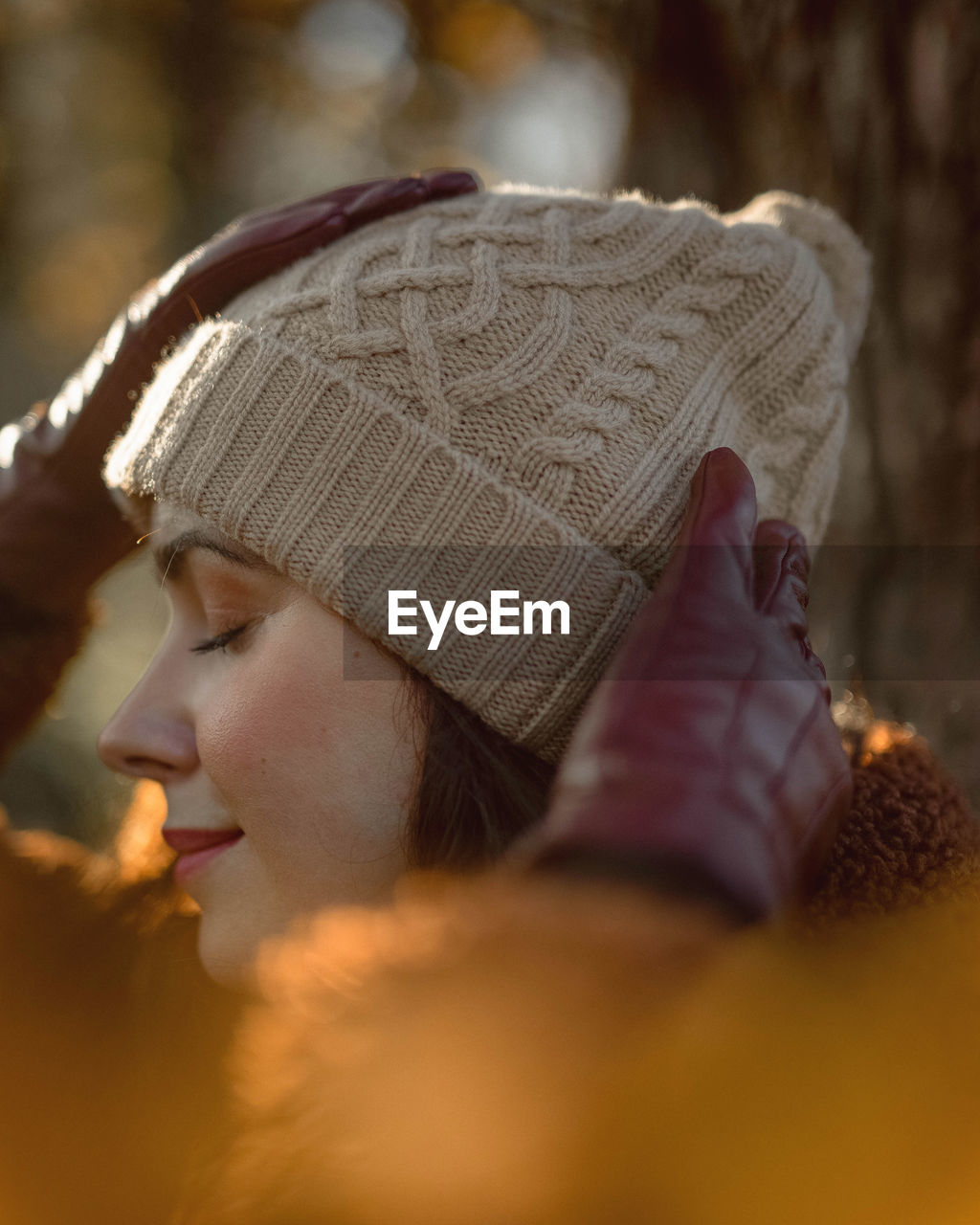 Close-up of beautiful woman wearing knitted hat during cold months winter or autumn 