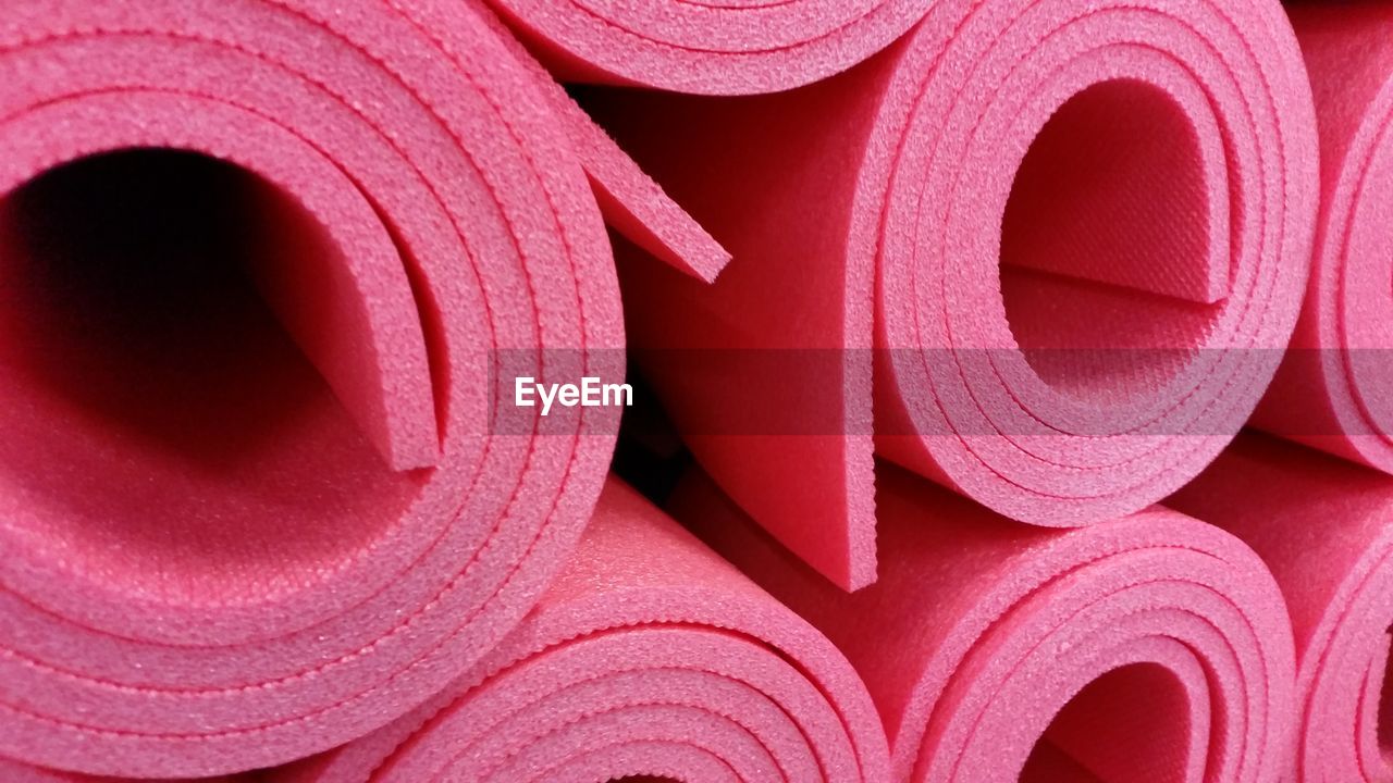 Close-up of pink exercise mat rolled up