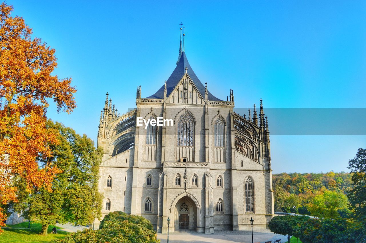 Low angle view of trees and st barbara cathedral against sky