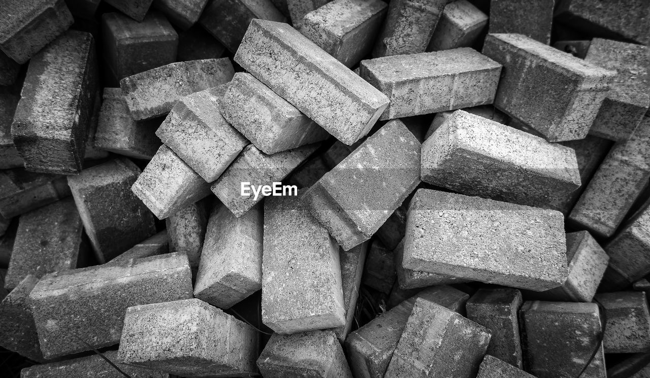 large group of objects, full frame, black and white, backgrounds, abundance, monochrome, monochrome photography, no people, iron, brick, pattern, heap, repetition, still life, close-up, black, rock, textured, wood, wall, shape