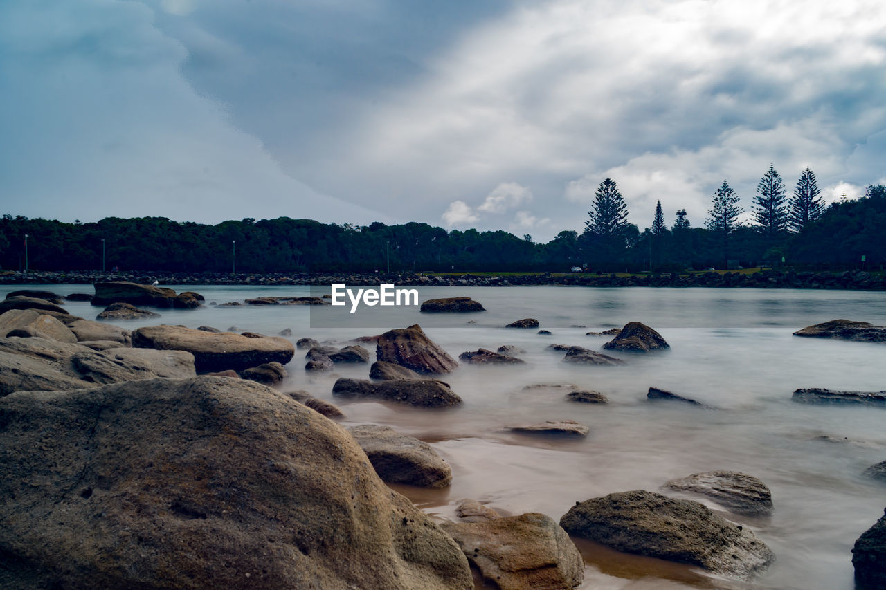 Rocks on shore against sky