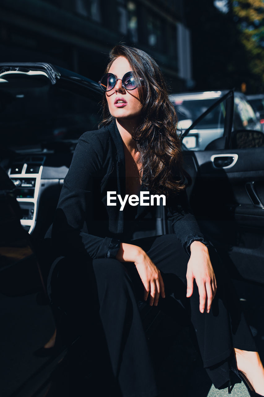 WOMAN SITTING IN CAR