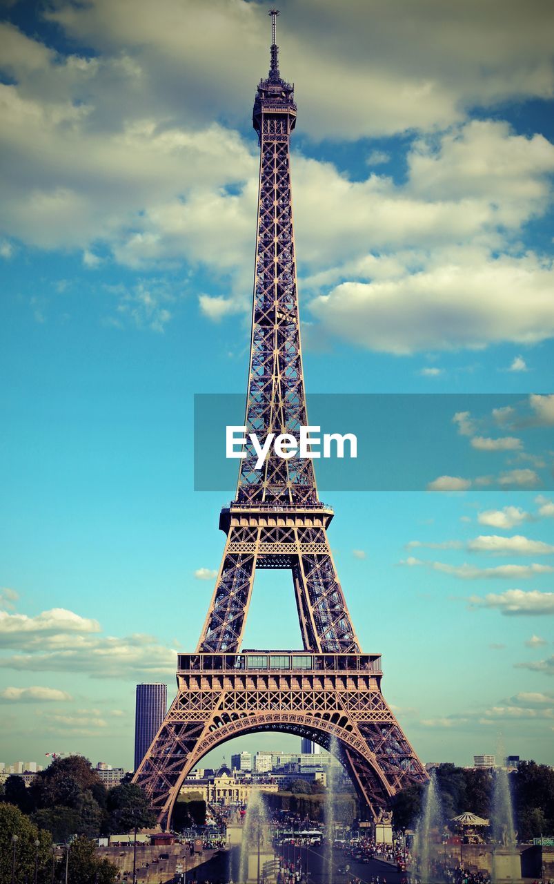 Eiffel tower in paris with white clouds in the sky and a vintage antique effect 