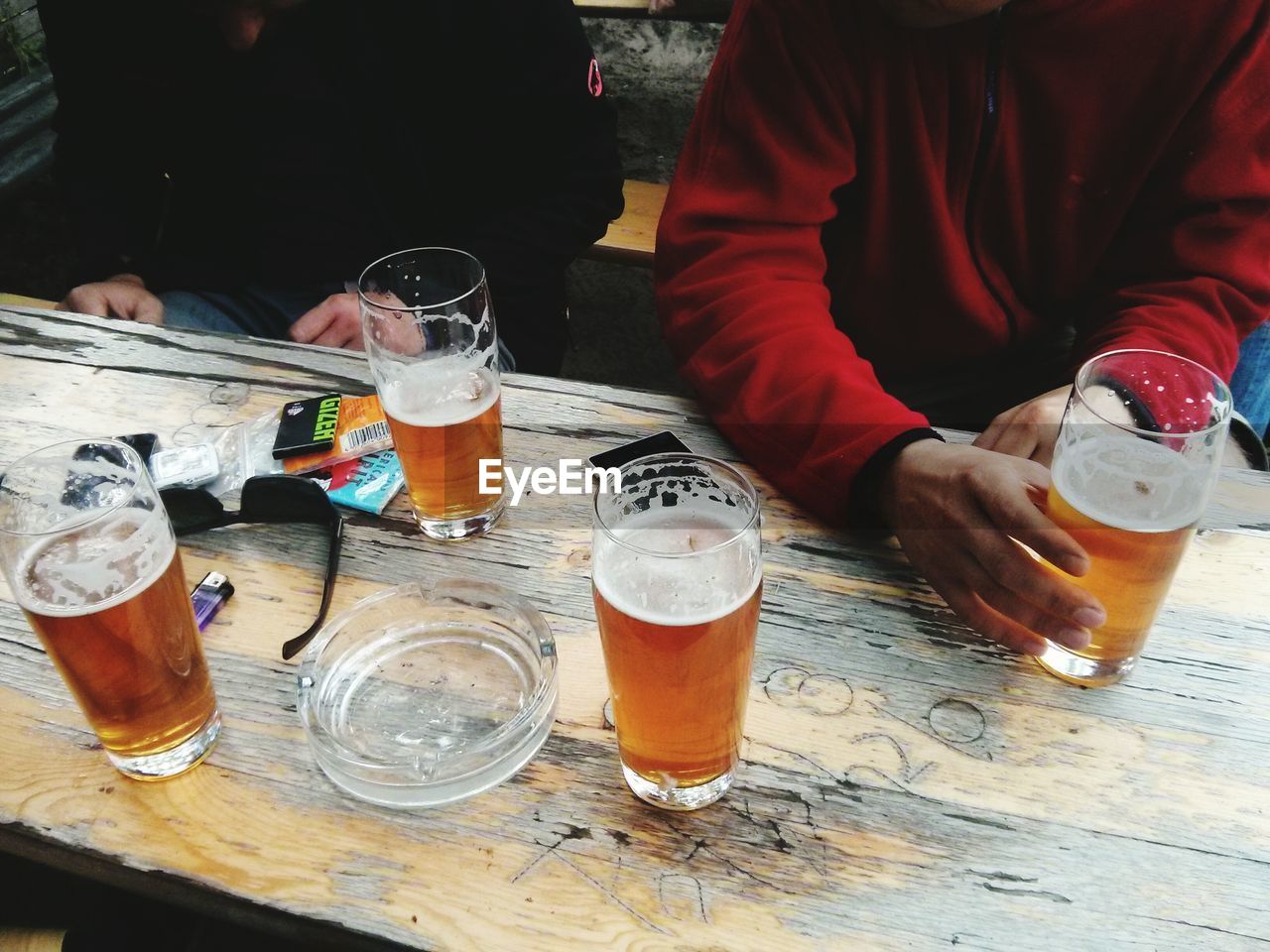 CLOSE-UP OF BEER GLASS ON TABLE