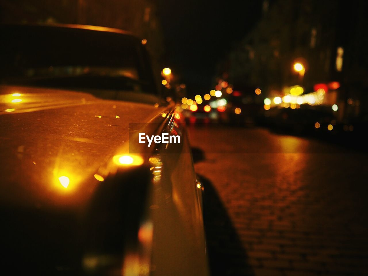 Close-up of car on road in city at night