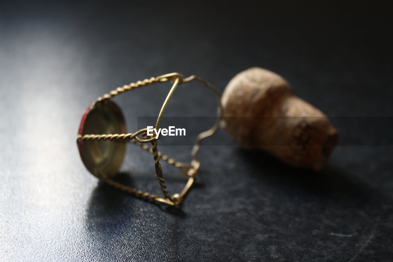 Close-up of champagne cork and muselet on table