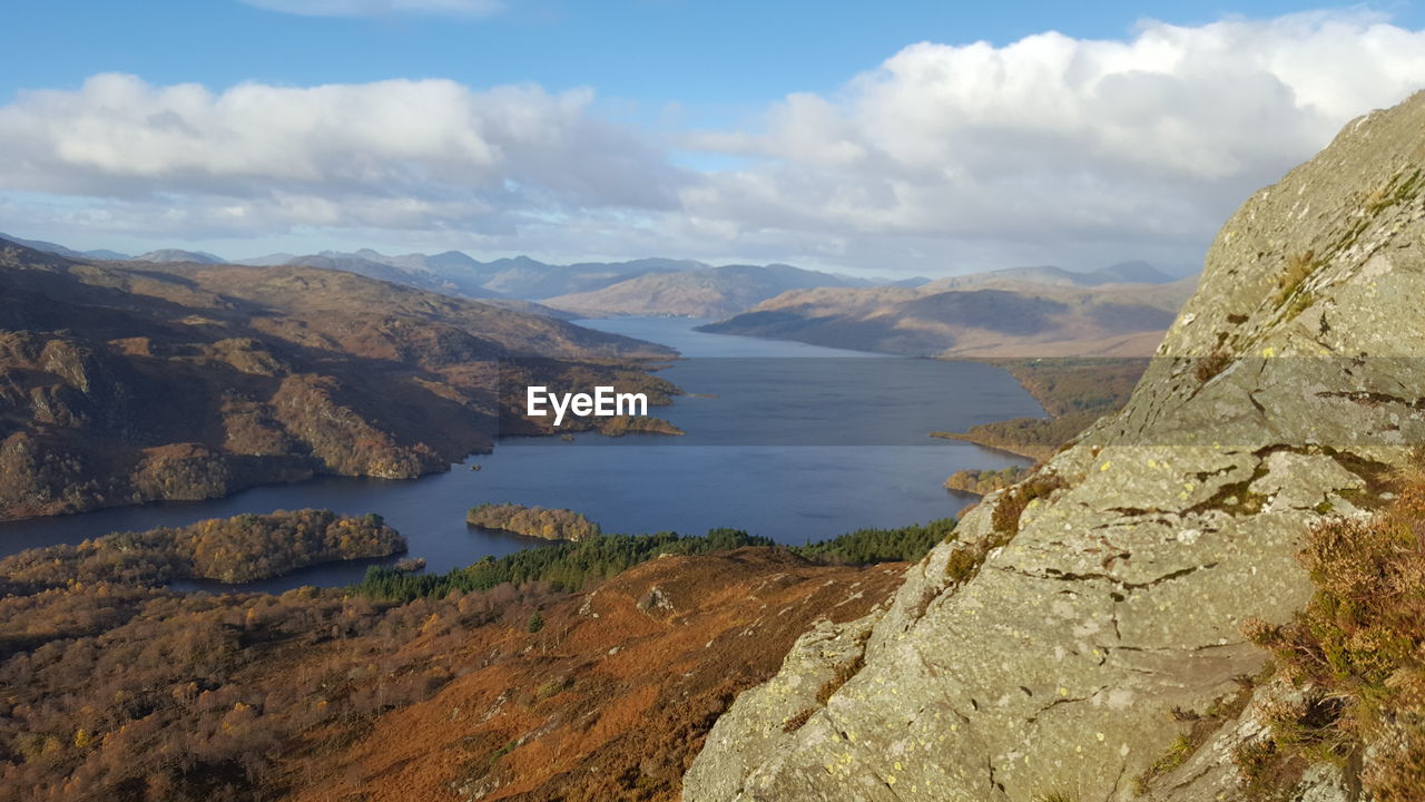 Scenic view of sea and mountains against sky