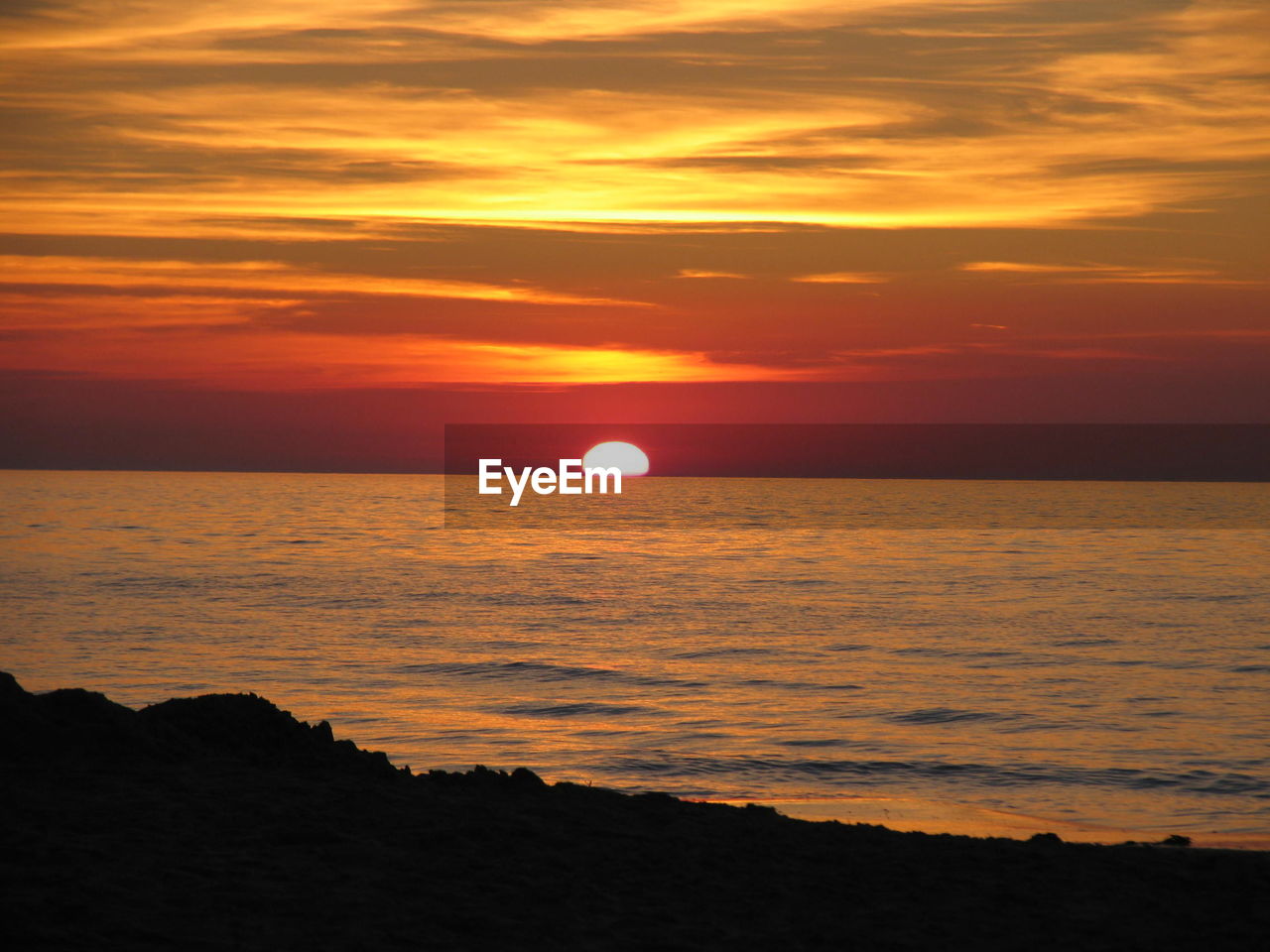 SCENIC VIEW OF SEA AGAINST ORANGE SKY DURING SUNSET