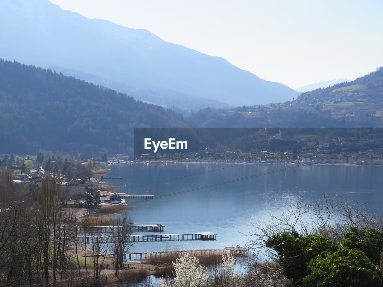 Scenic view of lake by mountains against sky