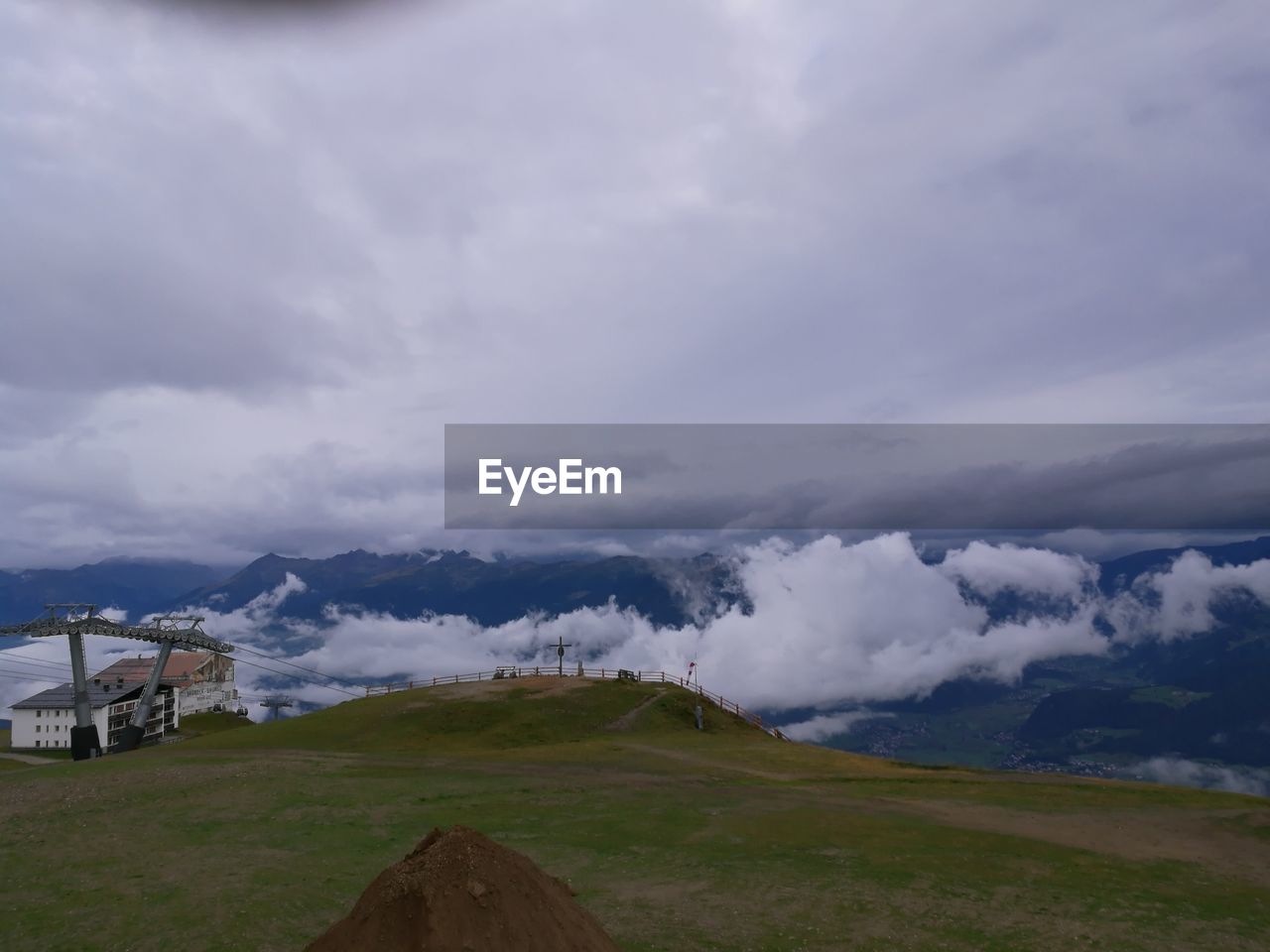 Scenic view of mountains against cloudy sky