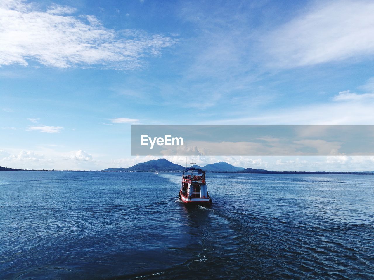 Boat sailing on sea against sky