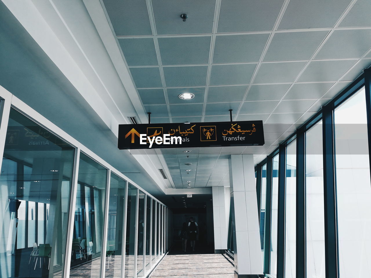 LOW ANGLE VIEW OF ILLUMINATED SIGN AT AIRPORT ENTRANCE TO BUILDING