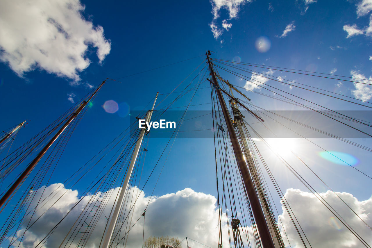 Low angle view of cables against blue sky