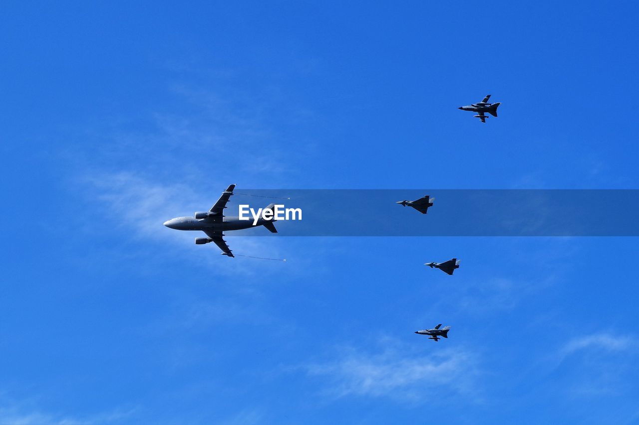 LOW ANGLE VIEW OF AIRSHOW AGAINST SKY