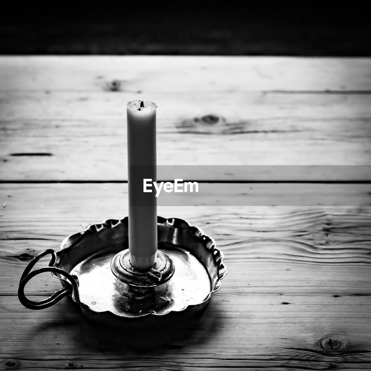 High angle view of candle on wooden table