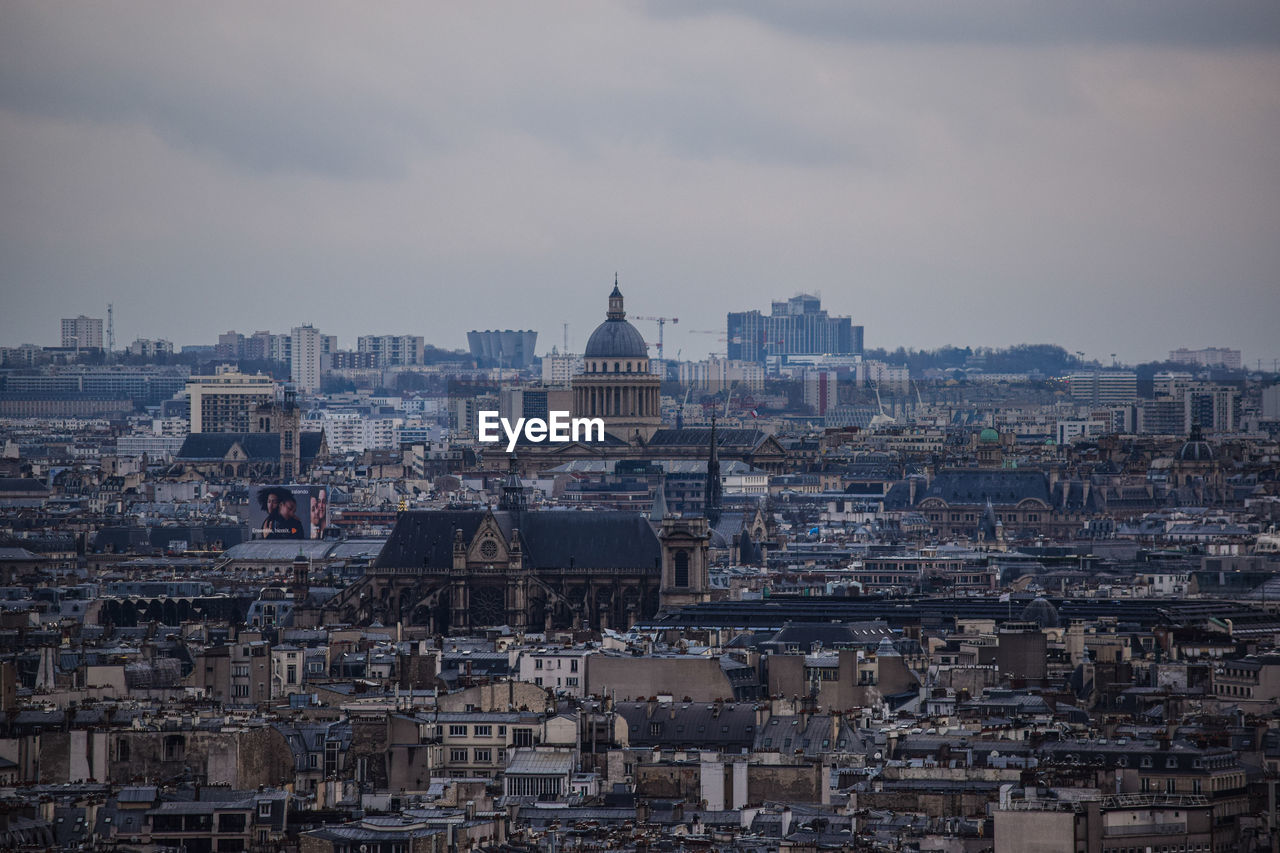 The view on the parisian rooftops from montmartre on a gloomy day, or, the french capital cityscape.