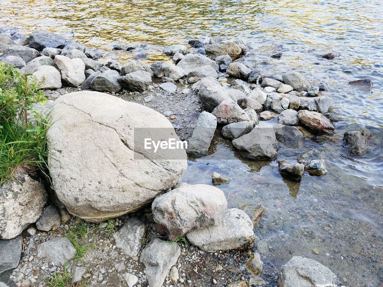 ROCKS ON SHORE AGAINST SKY