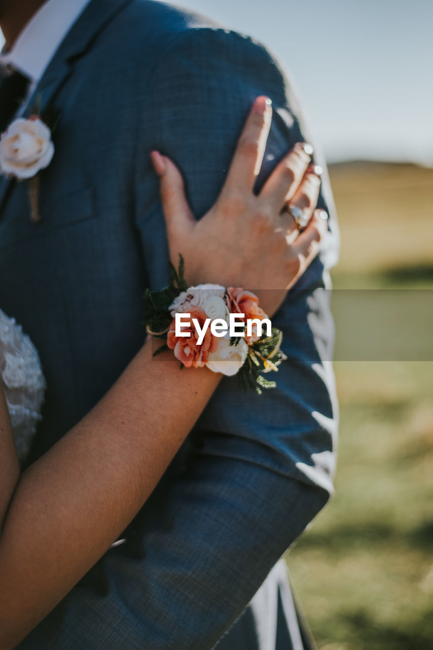 Close-up of woman hand holding red flower