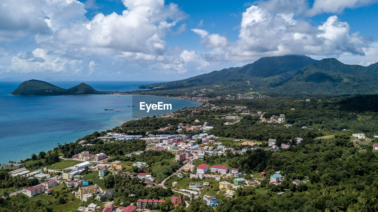 High angle view of townscape by sea against sky