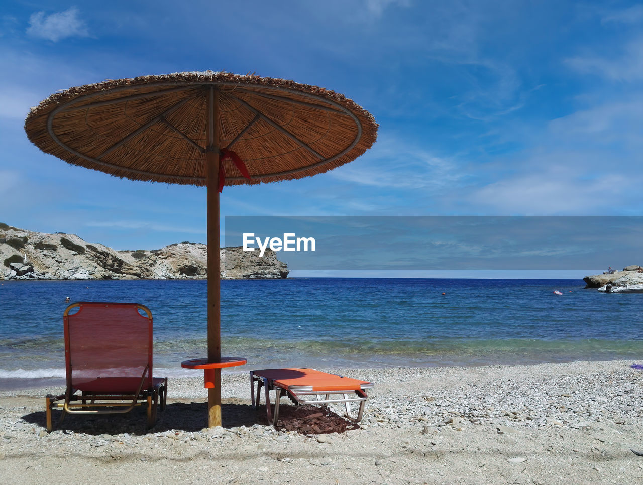 DECK CHAIRS ON BEACH AGAINST SEA