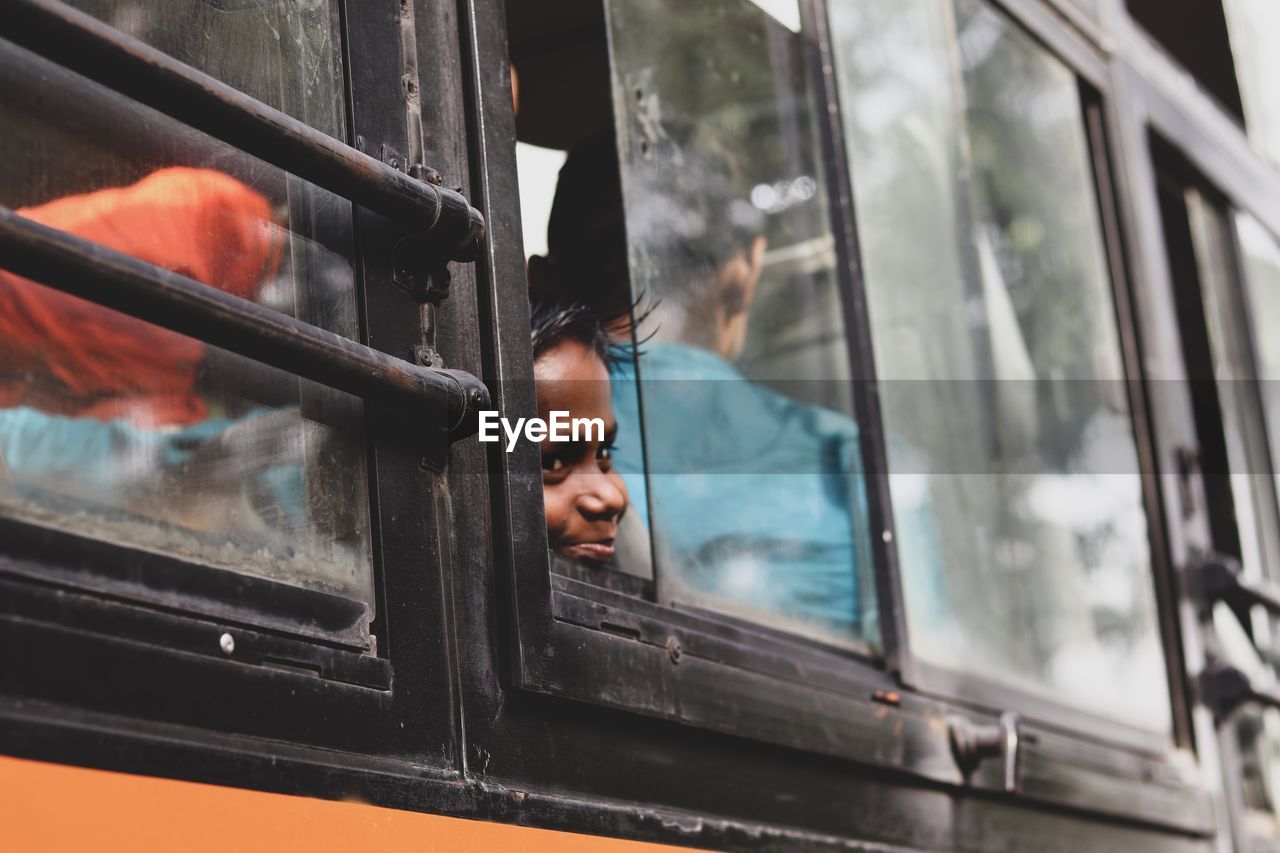 Boy looking through bus window