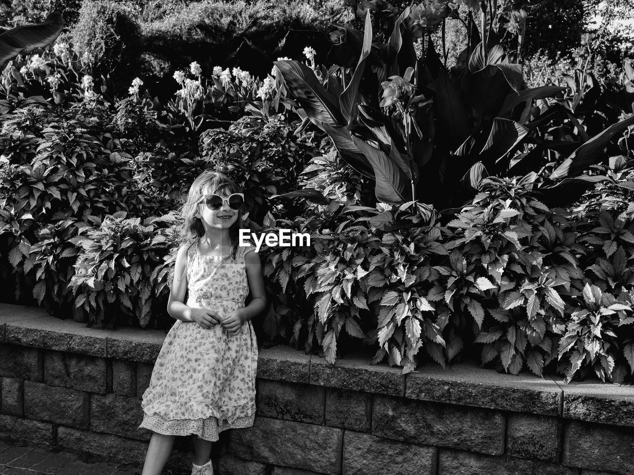 Girl standing by plants