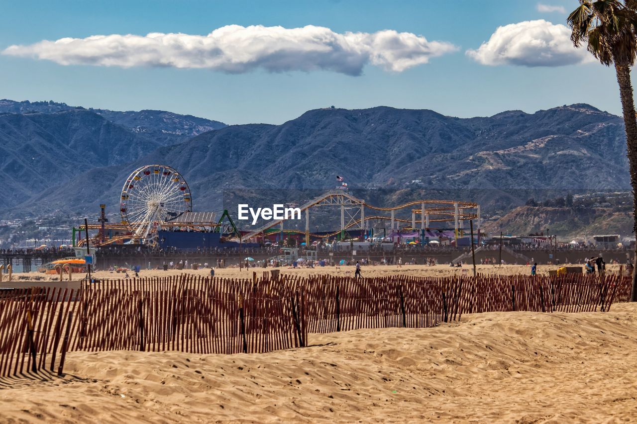 View of amusement park against cloudy sky