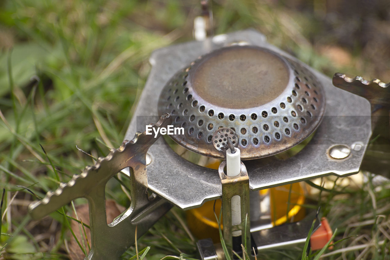 HIGH ANGLE VIEW OF MACHINERY ON FIELD BY PLANTS