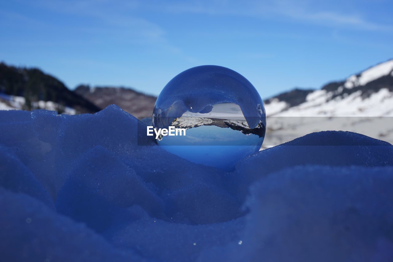 Close-up of frozen glass on mountain