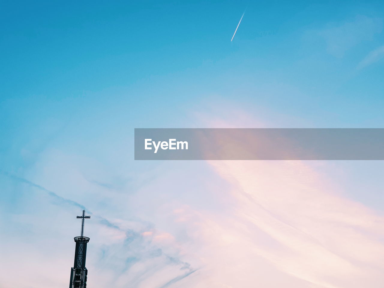 Low angle view of cross against sky at sunset