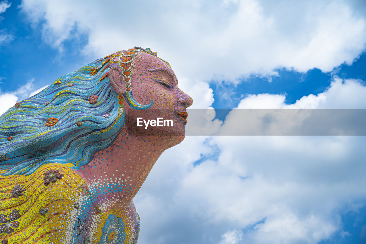 blue, cloud, sky, statue, nature, multi colored, religion, low angle view, adult, one person, outdoors, spirituality, day, digital composite, sculpture, creativity, side view, belief, travel, environment, architecture, representation, beauty in nature, art