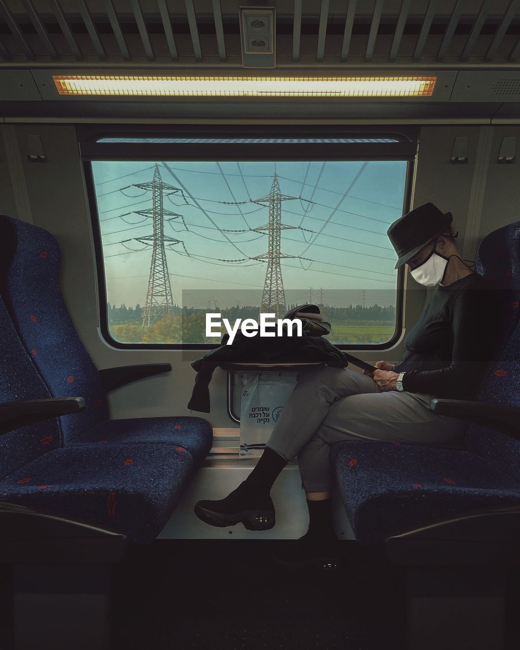 TRAIN ON RAILROAD STATION PLATFORM SEEN THROUGH WINDOW