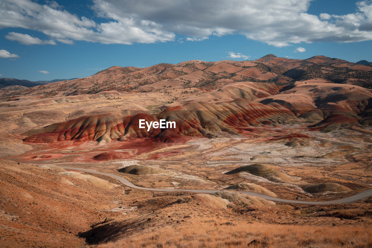 The painted hills in oregon. pretty unique and colorful mountain with red stripes on it.