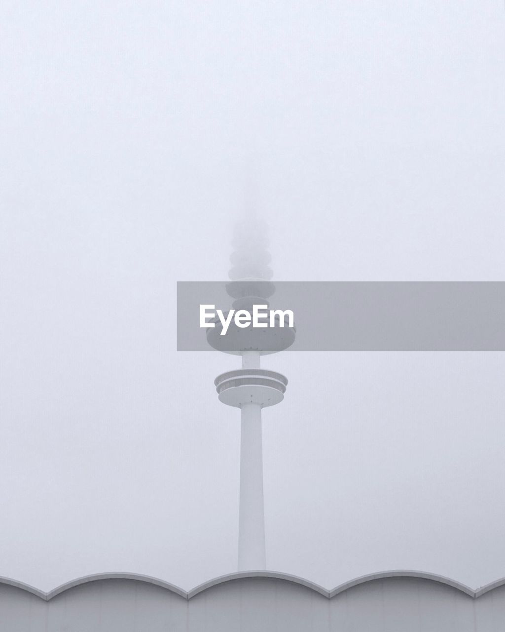 Low angle view of communications tower against sky