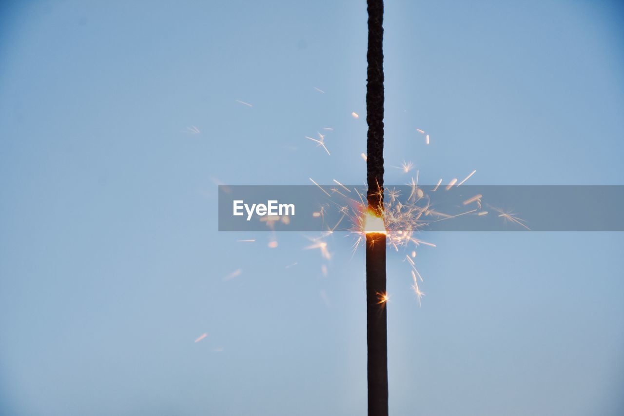 fireworks, sky, illuminated, celebration, motion, event, nature, low angle view, burning, blue, no people, arts culture and entertainment, copy space, blurred motion, night, outdoors, glowing, clear sky, long exposure, firework display, exploding, firework - man made object, sparkler, sparks, light, smoke