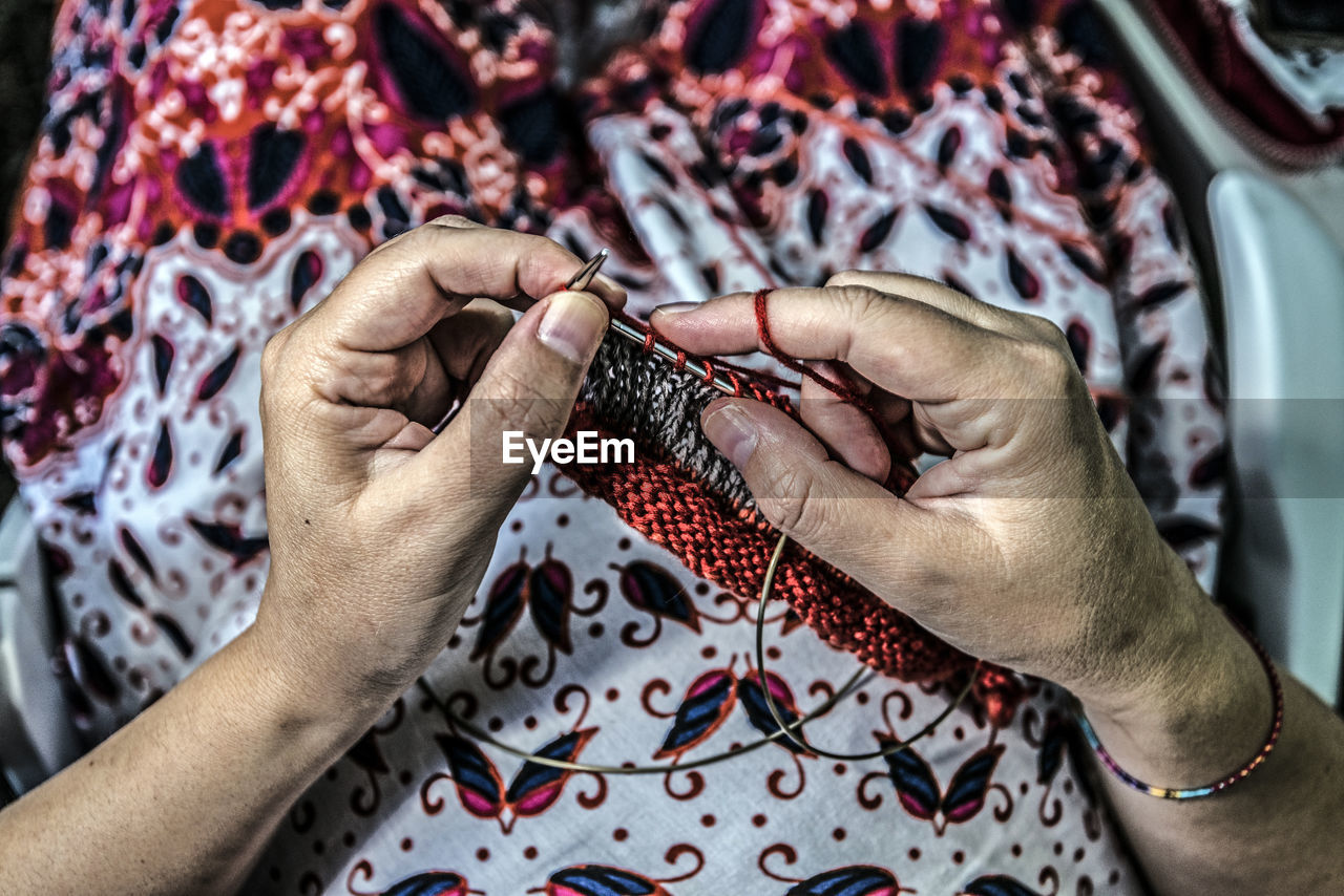 Midsection of woman knitting wool