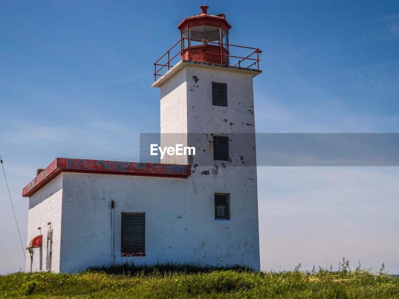 Low angle view of beacon against blue sky