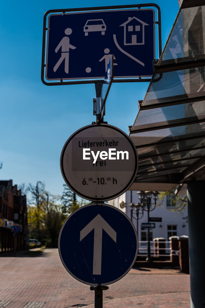 Information sign on road against sky