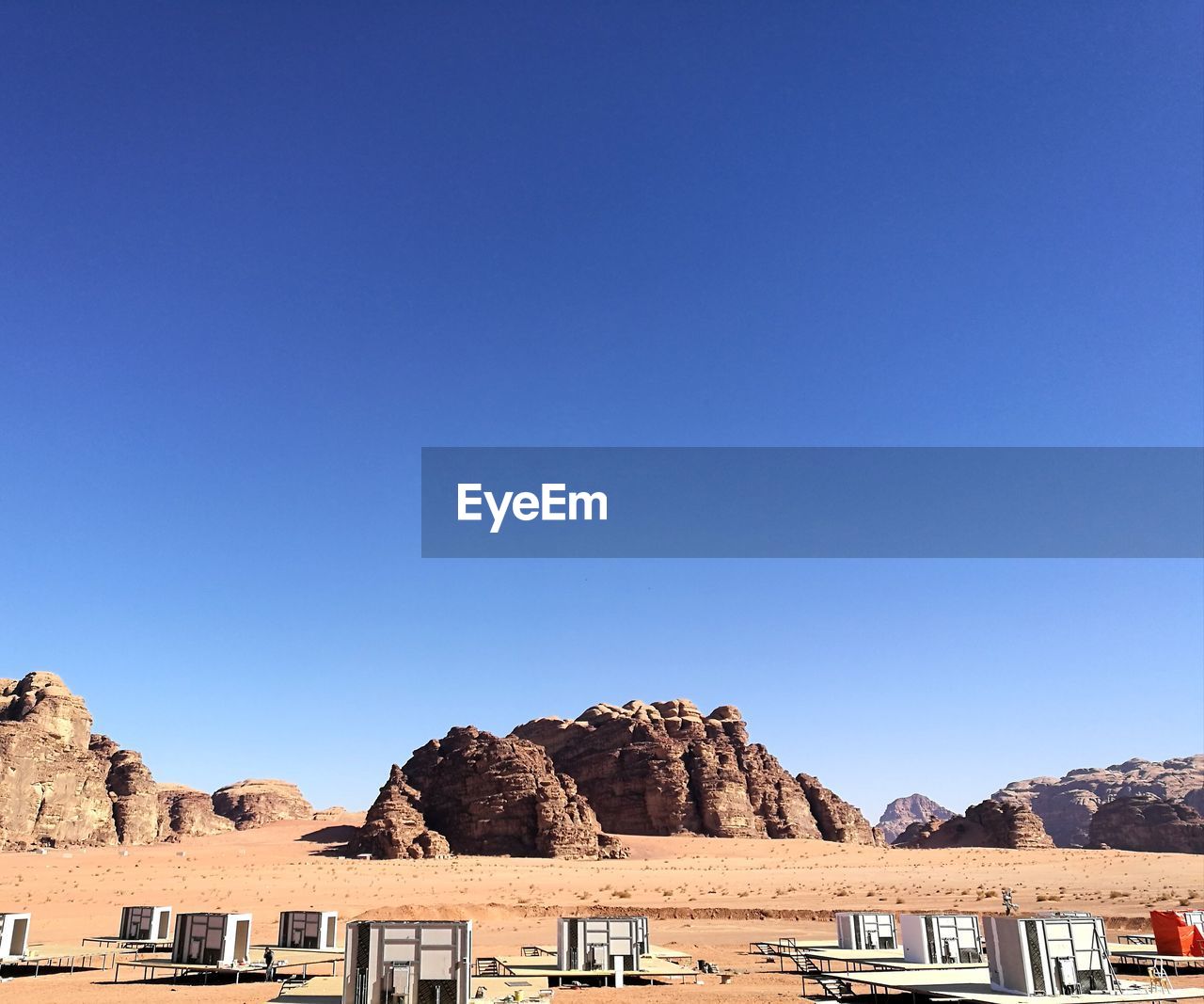 PANORAMIC VIEW OF ROCKS AGAINST CLEAR BLUE SKY