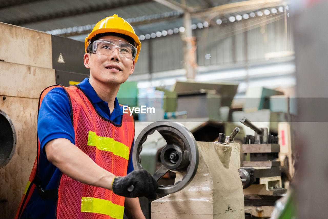 FULL LENGTH OF MAN WORKING IN MACHINE